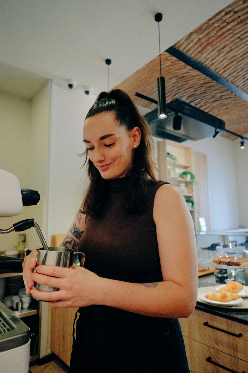 Steaming milk at the espresso machine